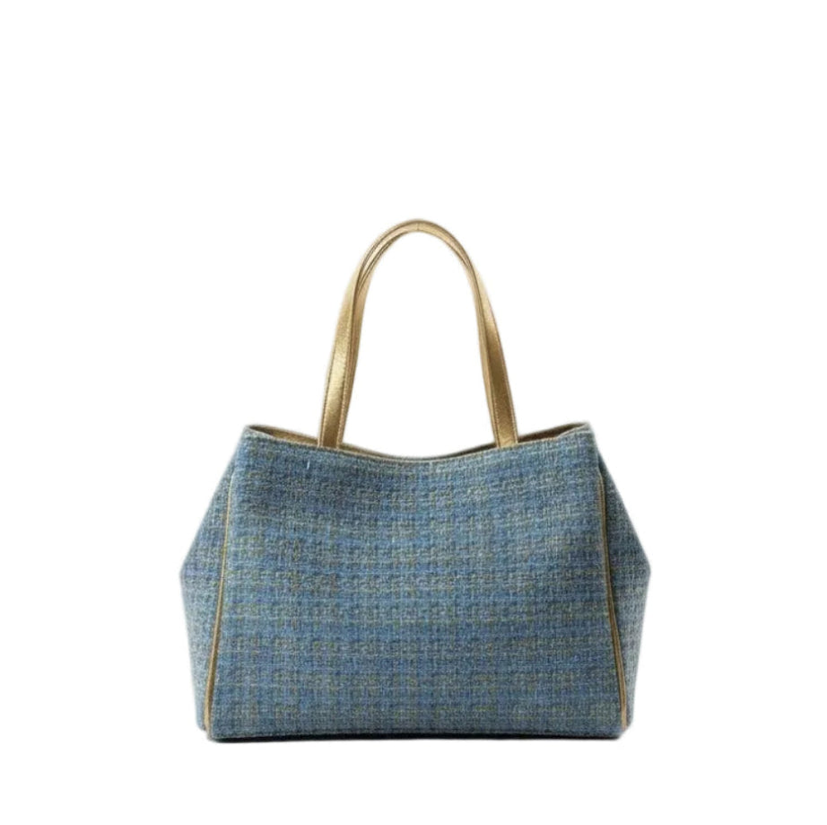 Blue tweed textured tote bag with gold accents on a white background