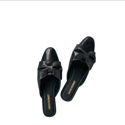 Shop Sarah Stewart Beverly Bow Mule in black lizard-embossed patent leather with a chic bow detail.