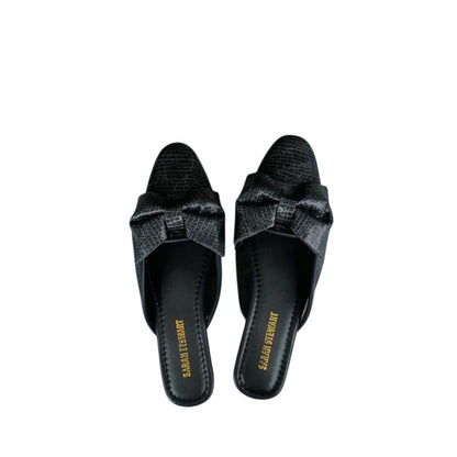 Shop Sarah Stewart Beverly Bow Mules in black lizard-embossed patent leather with a chic bow detail.