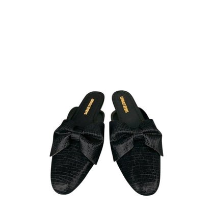Shop Sarah Stewart black patent leather Beverly Bow Mules featuring a lizard embossed texture and a decorative bow.
