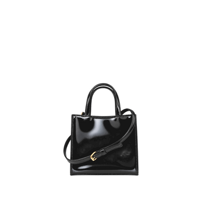 Shop Sarah Stewart black patent leather mini tote with gold hardware and adjustable shoulder strap in a boutique.