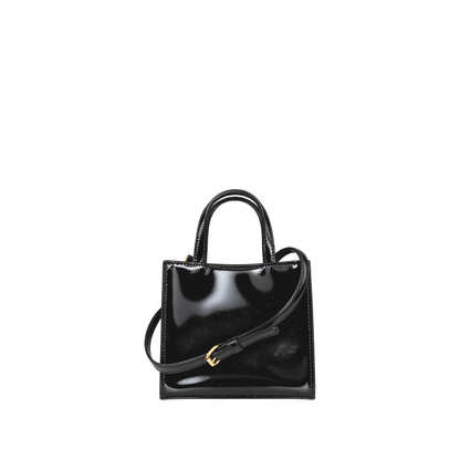 Shop Sarah Stewart black patent leather mini tote with gold hardware and adjustable shoulder strap in a boutique.