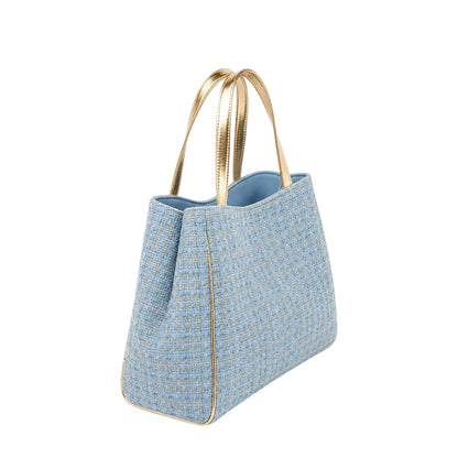 Shop Sarah Stewart Delilah Tweed tote bag in light blue tweed with metallic gold leather handles and trim.