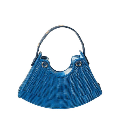 Shop Sarah Stewart blue handwoven wicker crescent bag with lambskin strap and gold floral accents.