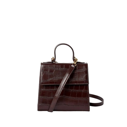 Shop Sarah Stewart The Robin handbag in dark brown crocodile-embossed goat skin leather with gold hardware.