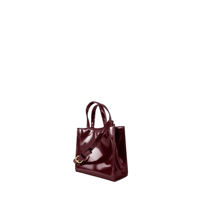Shop Sarah Stewart Addie mini handbag in glossy burgundy patent leather with structured silhouette and shoulder strap
