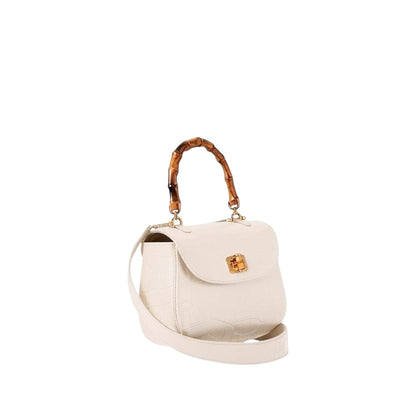 Shop Sarah Stewart The Chloe off-white embossed goat skin suede handbag with a bamboo handle and gold closure.