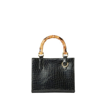 Shop Sarah Stewart Clara mini handbag in black goat skin with a crocodile texture and natural bamboo top handles.