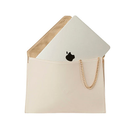 Shop Sarah Stewart cream vegan leather laptop clutch with a gold chain strap and a laptop inside