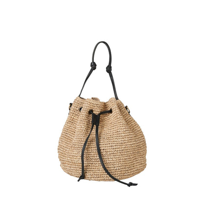 Shop Sarah Stewart The Jane natural raffia drawstring bucket bag with black leather handle and strap.