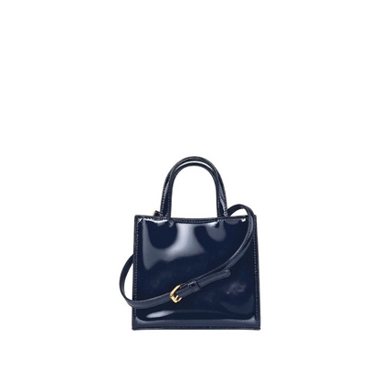 Shop Sarah Stewart Addie mini handbag in navy blue patent leather with a structured design and gold hardware.