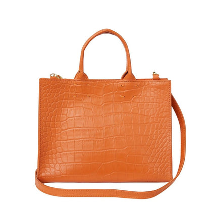 Shop Sarah Stewart Adelaide handbag in orange embossed goat skin leather with a detachable crossbody strap.