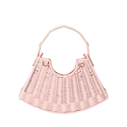 Shop Sarah Stewart pink handwoven wicker crescent bag with leather strap and gold floral accents.