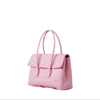 Shop Sarah Stewart light pink handwoven recycled plastic mini Kelly handbag with a snap fold top closure.