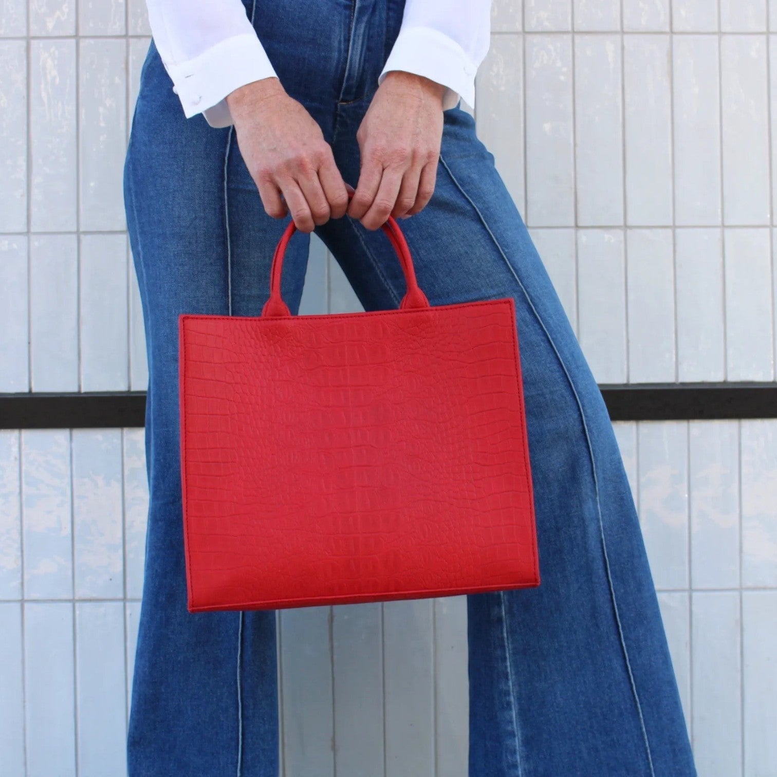 Shop Sarah Stewart red croc-embossed leather Adele handbag held by a woman in a white shirt and blue jeans