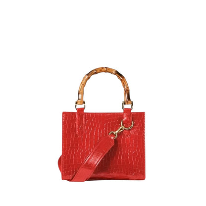 Shop Sarah Stewart red goat skin Clara mini handbag with bamboo handles, gold hardware, and detachable crossbody strap.