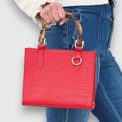 Shop Sarah Stewart red goat skin mini handbag with bamboo handles, gold hardware, and crocodile-embossed texture.