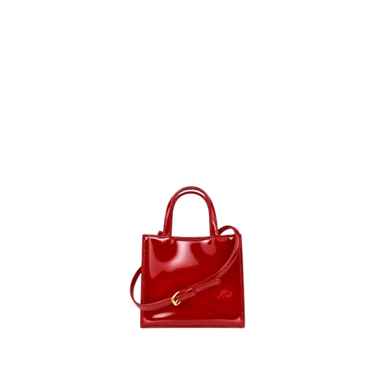 Shop Sarah Stewart Addie mini handbag in glossy red patent leather with structured design and gold hardware.
