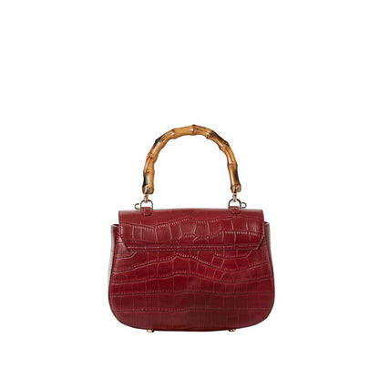Shop Sarah Stewart Chloe handbag in red embossed goat skin suede with a bamboo handle and gold closure.