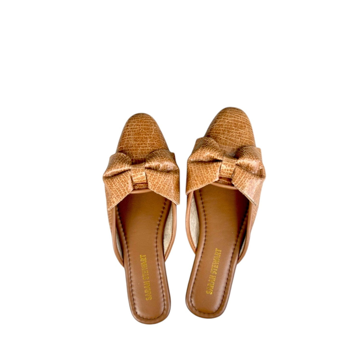 Shop Sarah Stewart Beverly Bow Mule in tan lizard-embossed patent leather with a decorative bow detail