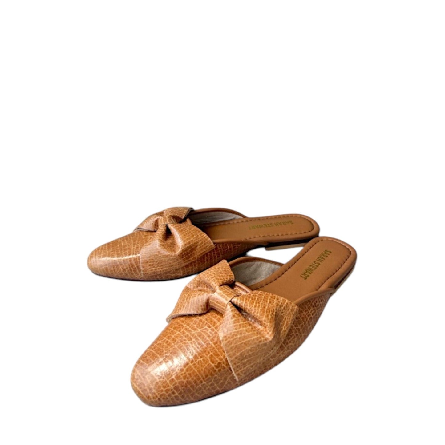 Shop Sarah Stewart Beverly Bow Mule in tan lizard-embossed patent leather with a decorative bow detail.