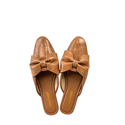 Shop Sarah Stewart tan patent leather Beverly Bow Mules with lizard embossed texture and a decorative front bow