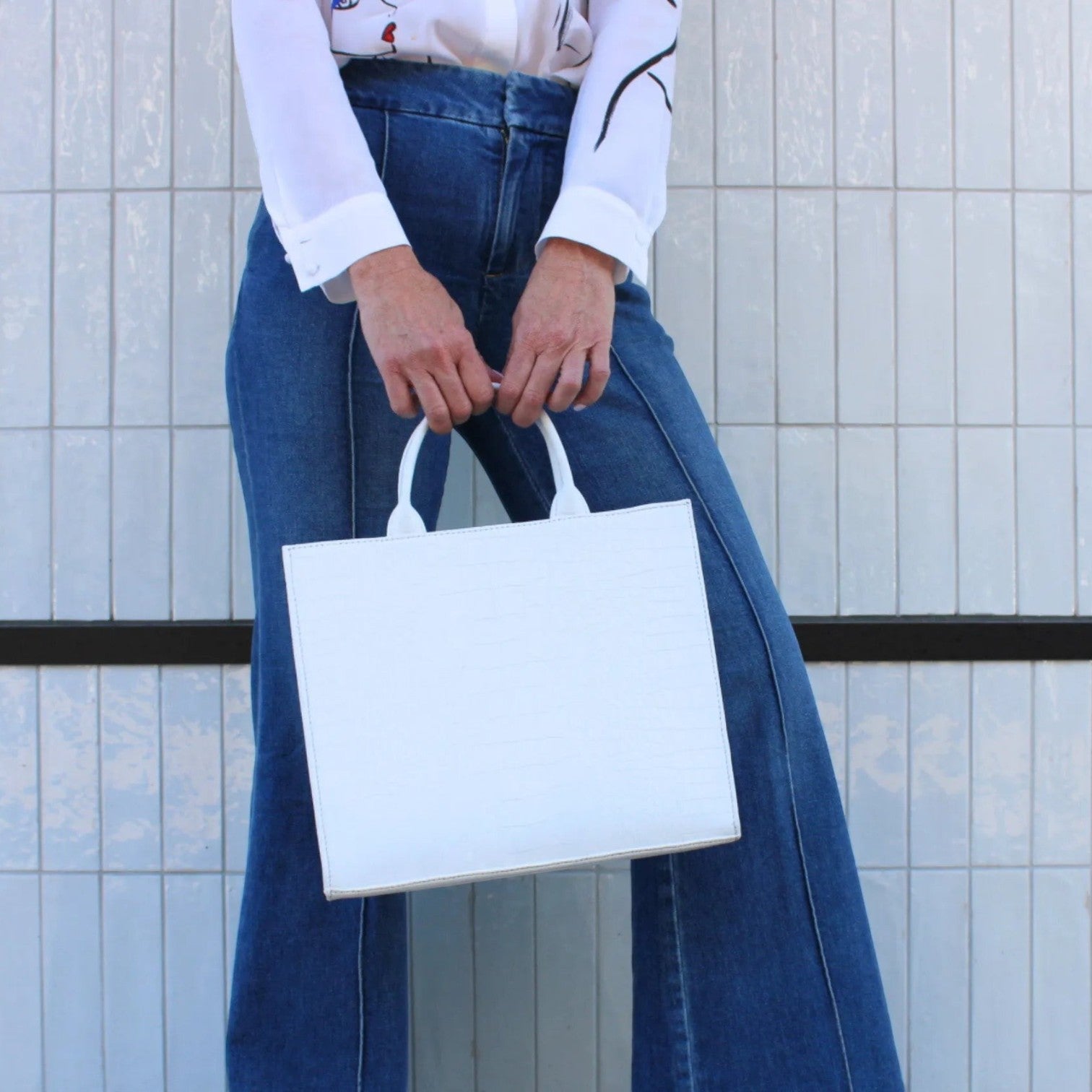 Shop Sarah Stewart white croc-embossed leather Adele handbag with structured rectangular design held by a model